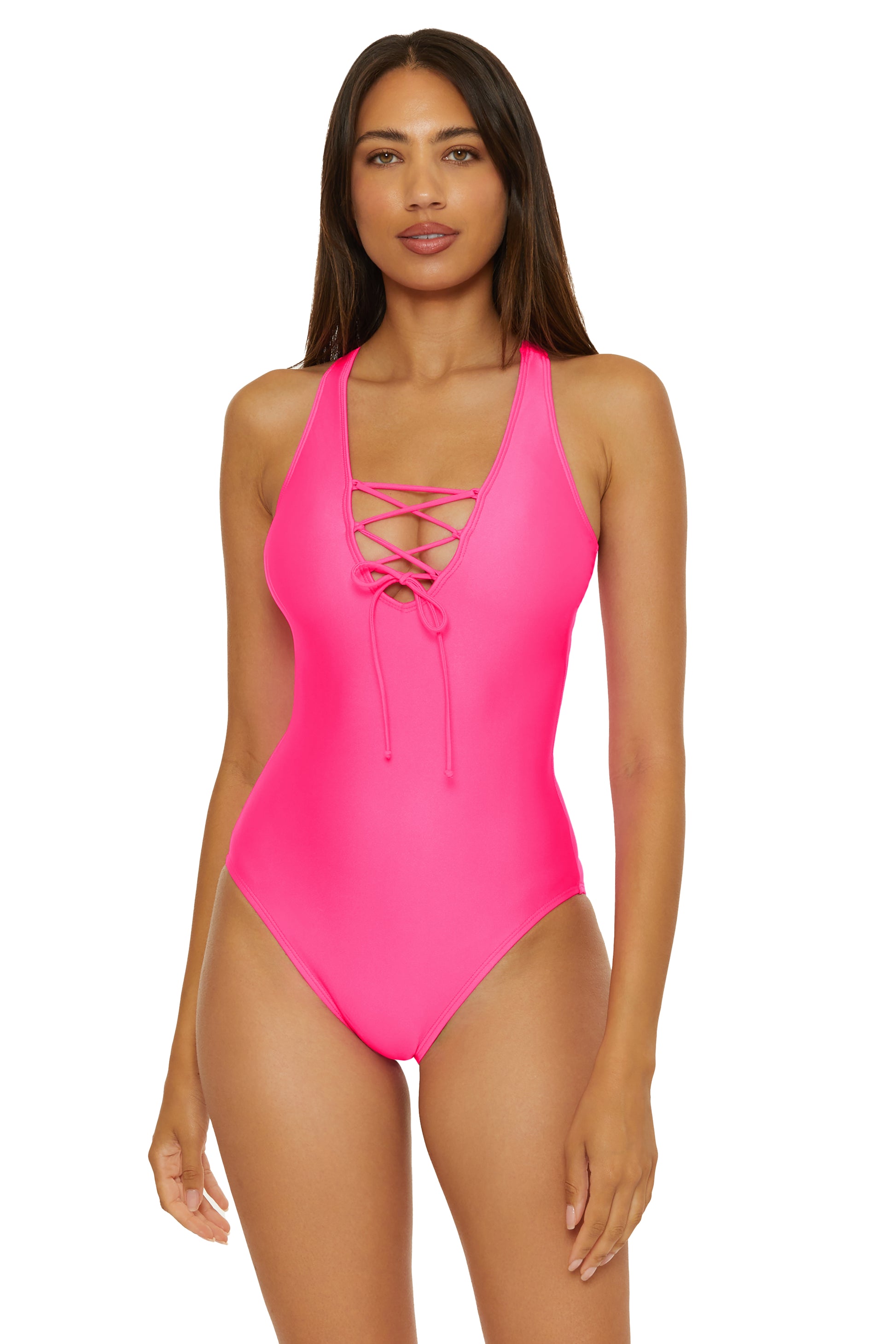 A woman wearing a black one-piece swimsuit with a scoop neckline and lace-up front in Neon Pink
